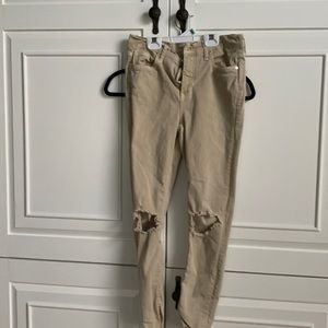 Ripped tan denim jeans